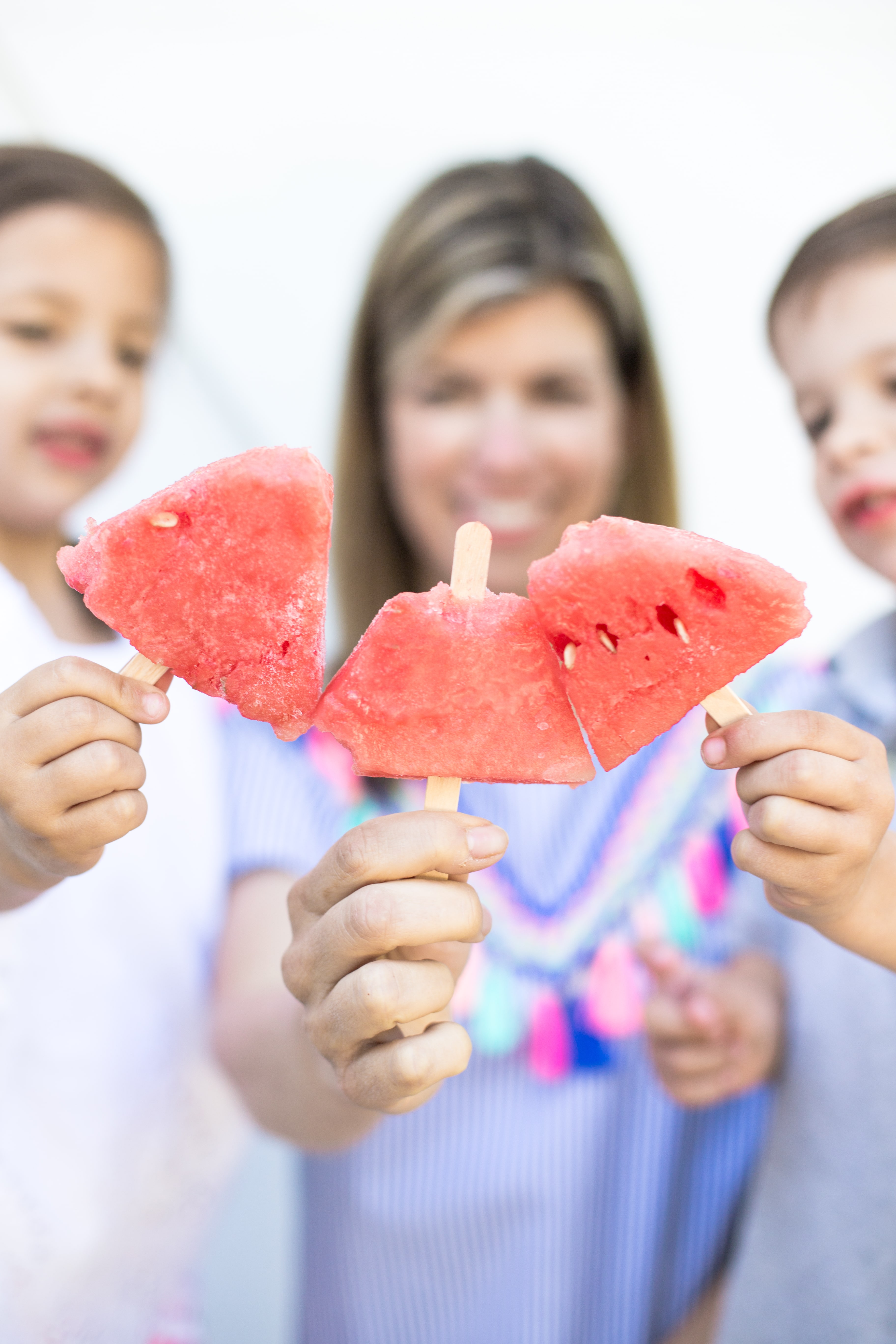 Mom and children show off their popsicles